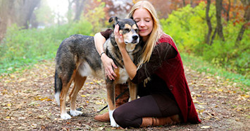 old dog and woman hugging on trail
